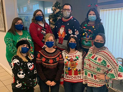 Plattsburgh West Employees Wearing Christmas Sweaters