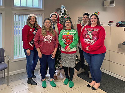 Group of People Wearing Holiday Sweaters
