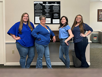 Four Women Wearing Jeans and Matching Shirts