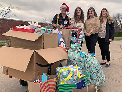 Four People with Boxes of Christmas Presents