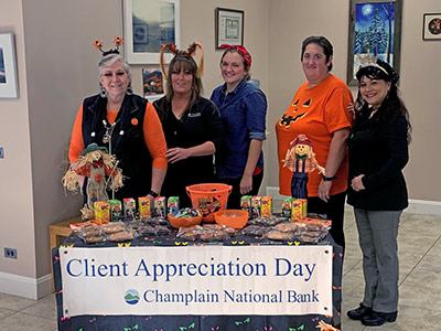 Lena, Juslyn, Lydia, Courtney, Michelle Standing Behind Treats Table