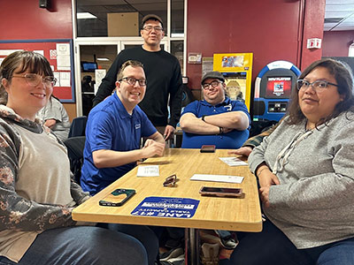 Five People Sitting Around a Table