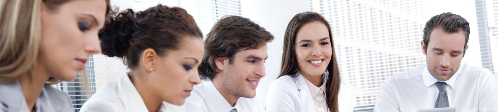 Young Business People Sitting at Conference Table