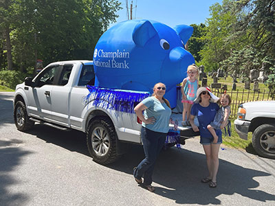 Autumn and Kurri with Two Young Children Posing in front of Truck with Inflatable Pig