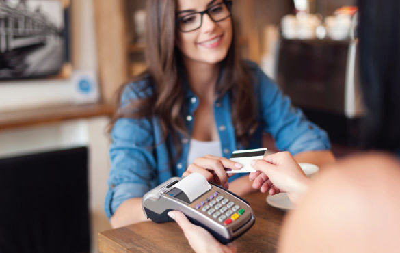 Woman Paying Using a Credit Card Terminal