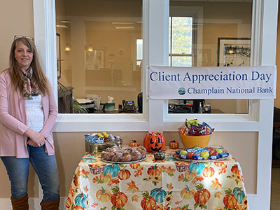 Lake Placid Employee Standing Next to Halloween Table of Treats