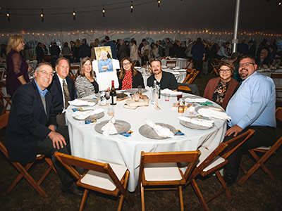 Group of People Sitting at a Round Gala Table