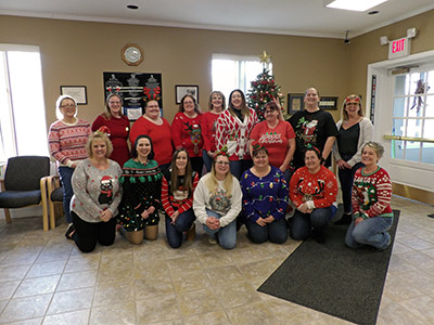 Group of People Wearing Holiday Sweaters