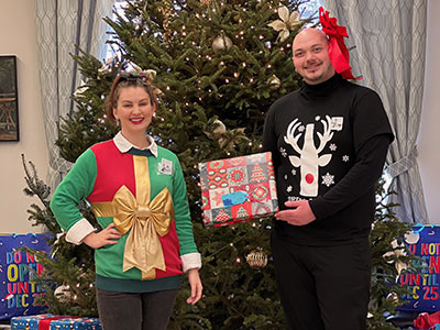 Two People Wearing Holiday Sweaters