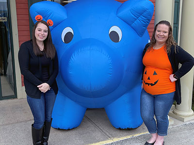 Champlain Employees Posing with Inflatable Pig