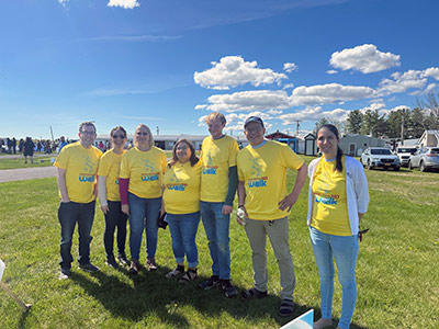 Group of People Wearing Jeans and Matching T-Shirts