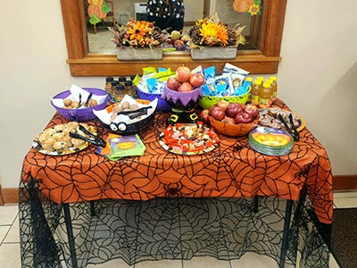 Table with Spider Web Tablecloth and Fall Treats