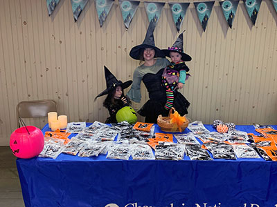 Kurri dressed as a witch with two children dressed as witches
