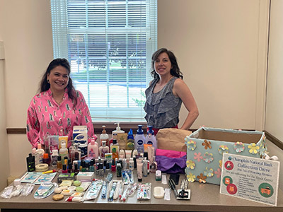 Two Women Standing with Hygiene Items