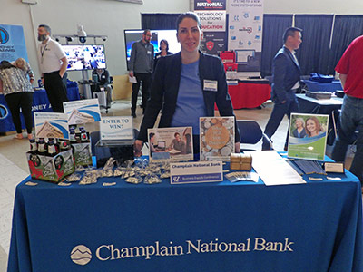 Ralitsa Standing Behind a Table of Information and Giveaways