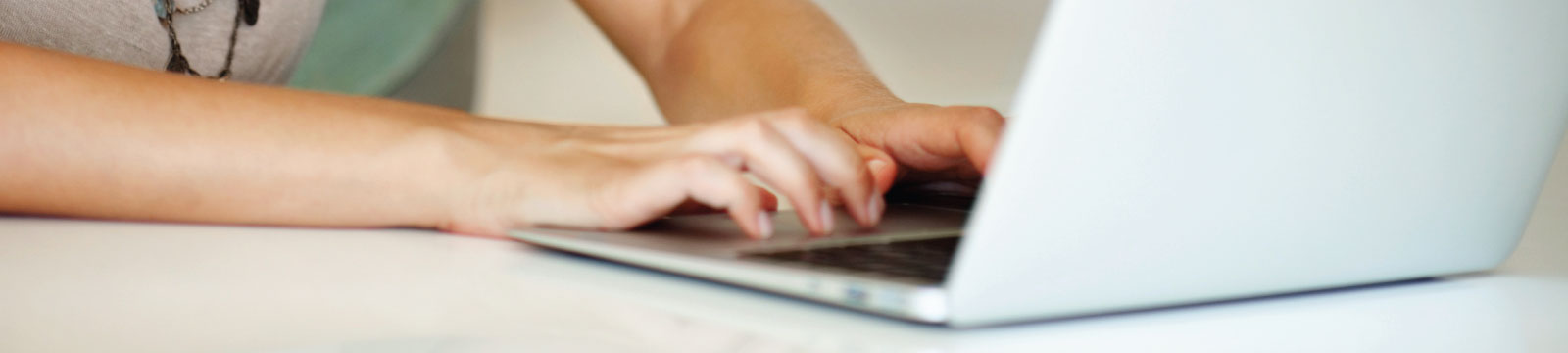 Hands Typing on a Laptop