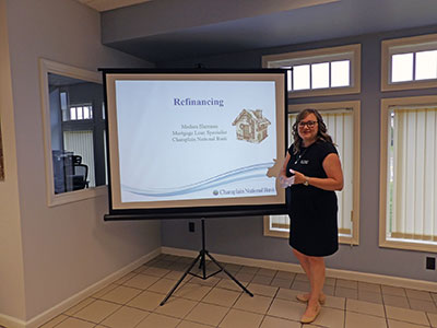 Medara standing in front of presentation screen