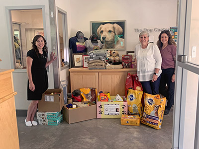 Kurri, Lena, and Wendy Standing Next to Boxes full of Pet Supplies